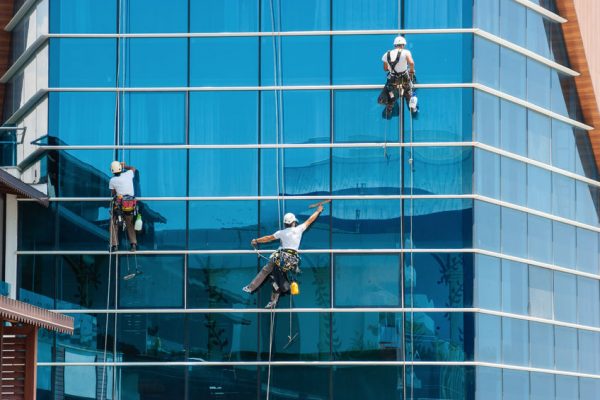 37192540 - workers washing windows of the modern skyscraper building